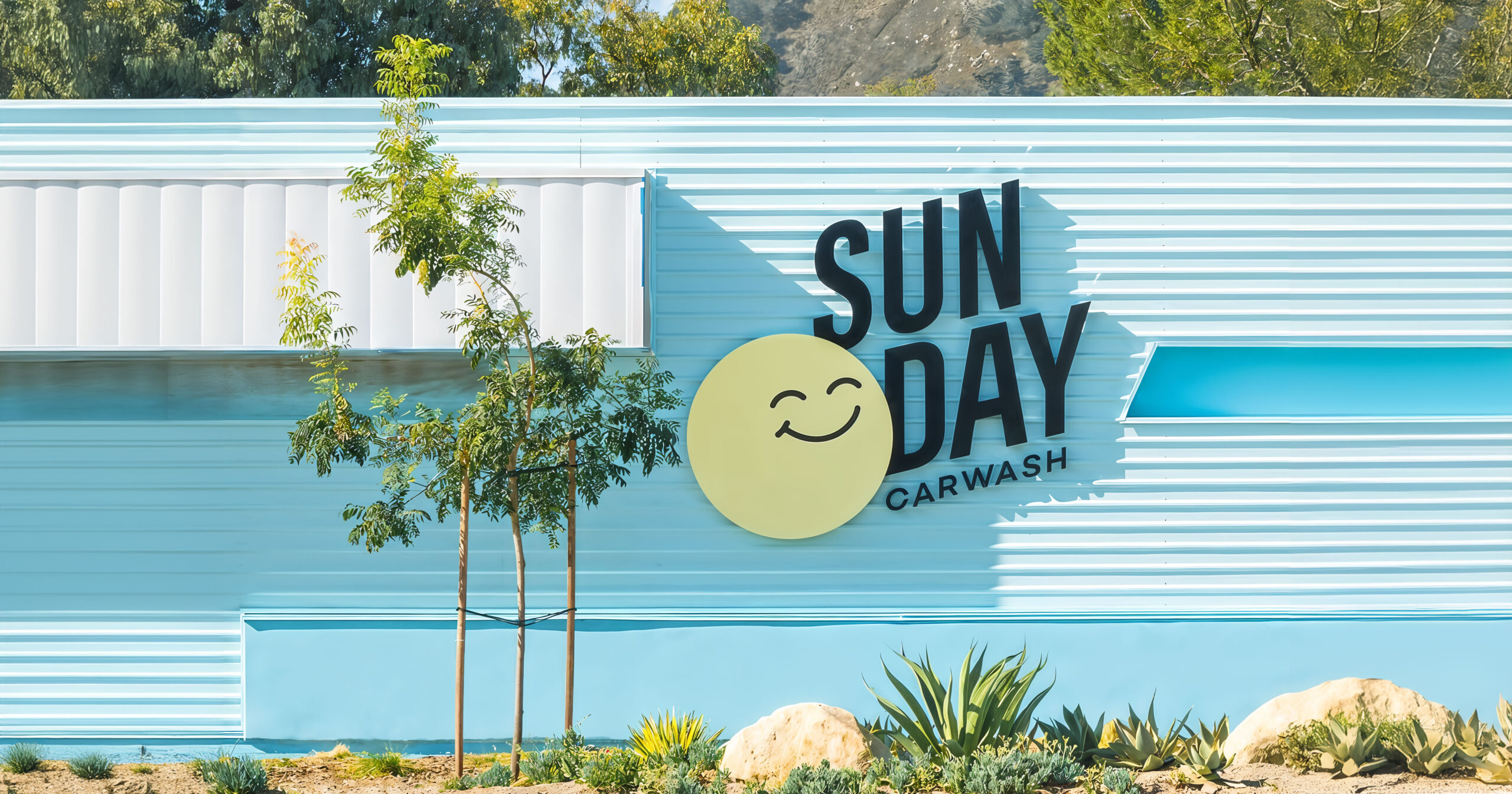 Exterior signage of Sun Day car wash logo in San Luis Obispo